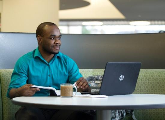 student working on a laptop in the Ingram Library